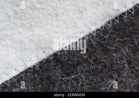 White and black felt sewn diagonally toothed stitch of white thread Stock Photo