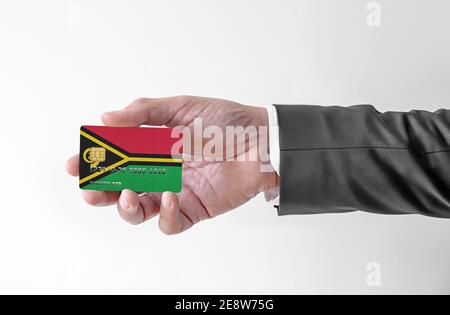 Bank credit plastic card with flag of Vanuatu holding man in elegant suit Stock Photo