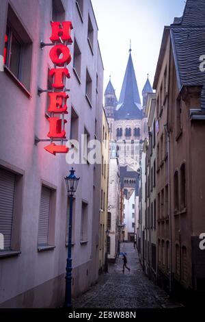 the lane Auf dem Rothenberg in the old part of the town, view to the church Gross St. Martin, hotel neon sign, Cologne, Germany.  die Gasse Auf dem Ro Stock Photo