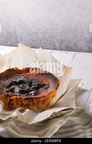 https://l450v.alamy.com/450v/2e8wbp4/basque-burnt-cheesecake-in-baking-paper-on-striped-linen-napkin-and-on-textured-white-wooden-table-selective-focus-tasty-homemade-spanish-dessert-l-2e8wbp4.jpg