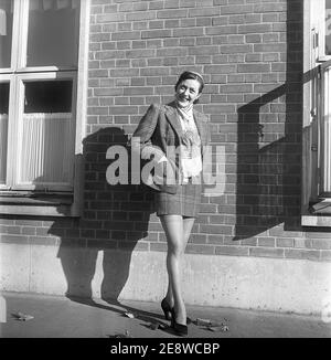Nylon stockings in the 1950s. The model Solveij Nyhlén pictured outside the swedish factory of nylon stockings, Malmö strumpfabrik. Established 1926 and became the leading manufacturer of silk stockings in sweden. At this time 1951 the company had invested in new machinery to make the popular nylon stockings. Ref BE20-3 Stock Photo