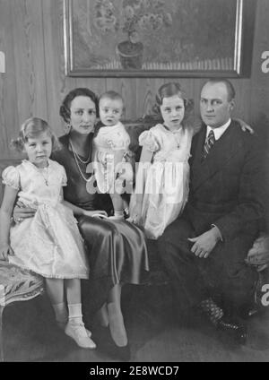 Crown Princess Märtha of Norway. 1901-1954. Daughter of swedish Prince Carl. Pictured here with her son and future king of Norway Crown Prince Harald in her lap with daughters Ragnhild and Astrid. Prince Harald was born on february 21 1937. On the right then being crown prince Olav V. Stock Photo