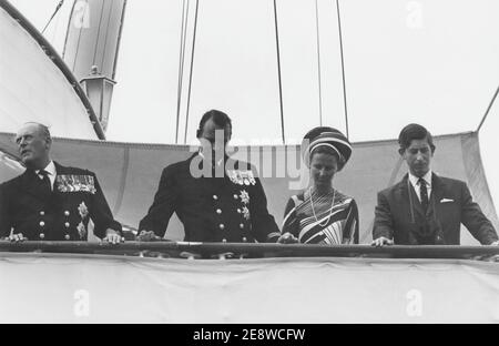 King Harald of Norway. Pictured when being crown prince with his wife Sonja and King Olav V when having Prince Charles of England visiting on the ship HMY Britannia in the 1960s Stock Photo
