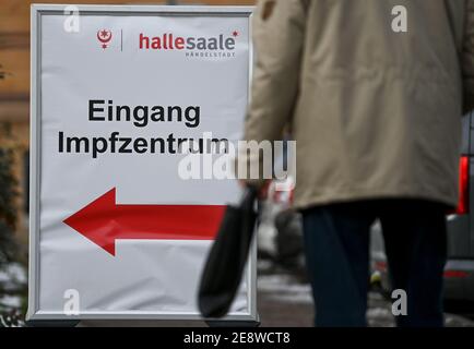 01 February 2021, Saxony-Anhalt, Halle (Saale): A sign in front of the vaccination centre in Halle/Saale shows the way to the entrance. The Federal Chancellor and the Minister Presidents of the federal states want to discuss improvements in corona vaccinations at a vaccination summit. Photo: Hendrik Schmidt/dpa-Zentralbild/dpa Stock Photo