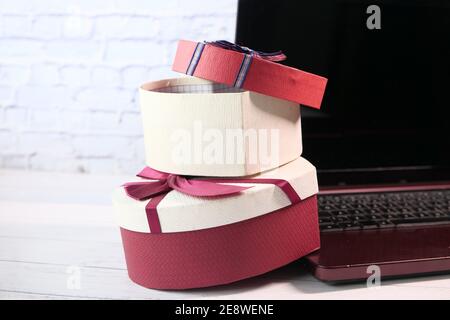 stack of gift box and laptop on table  Stock Photo