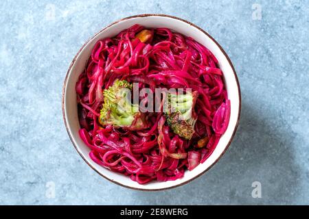 Beetroot Pad Thai Rice Noodles with Beet Flavored and Broccoli in Bowl. Ready to Eat and Serve. Stock Photo