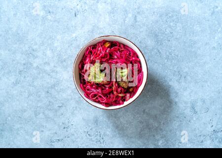 Beetroot Pad Thai Rice Noodles with Beet Flavored and Broccoli in Bowl. Ready to Eat and Serve. Stock Photo