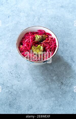 Beetroot Pad Thai Rice Noodles with Beet Flavored and Broccoli in Bowl. Ready to Eat and Serve. Stock Photo