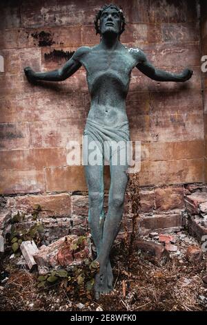 Christ uncrucified statueagainst stone wall. Stock Photo