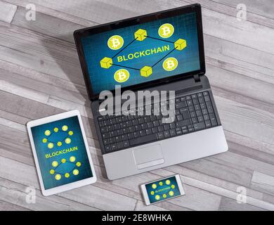 Blockchain concept shown on different information technology devices Stock Photo