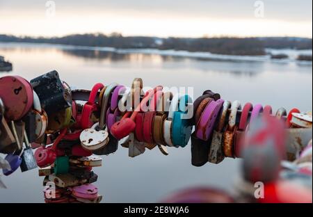 Many heart-shaped padlocks hang on the bridge Stock Photo