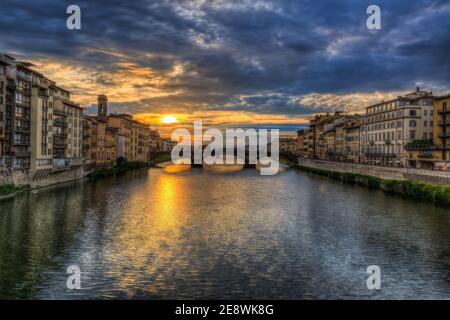 being in the middle of the ponte Vecchio and looking toward the Arno during a glorious florentine sunset Stock Photo