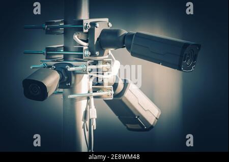 Three Modern Security Megapixel CCTV Cameras Installed on Aluminium Outdoor Pole. Closed Caption Television Technologies. Stock Photo