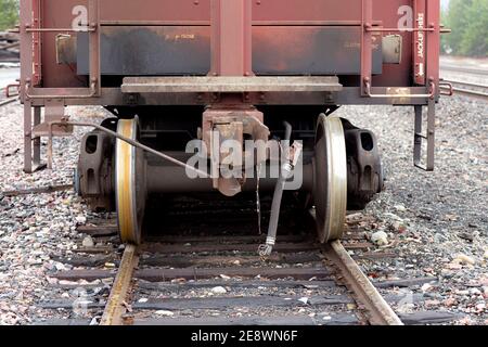 Railroad hopper car coupler, and truck wheels and axles, on the tracks, at the BNSF railroad yard, Troy, Montana.   Burlington Northern and Santa Fe R Stock Photo