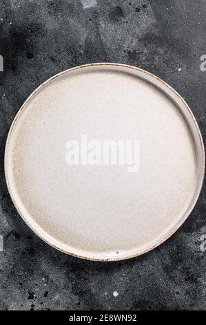 White empty round plate, restaurant background. Black background. Top view. Copy space. Stock Photo