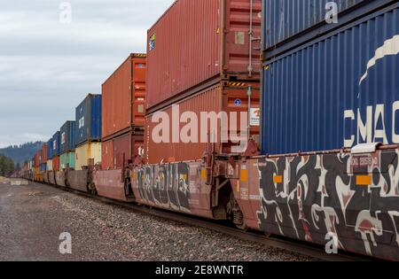 A line of intermodal container well cars through the BNSF rail yard in ...