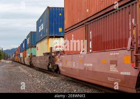 A line of intermodal container well cars through the BNSF rail yard in ...