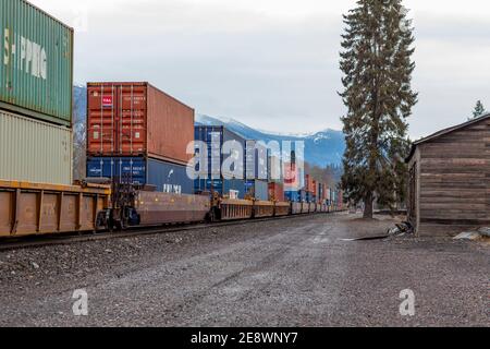 A line of intermodal container well cars through the BNSF rail yard in ...