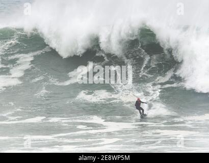 Newquay,Cornwall, 1st February 2021. UK weather: Devon and Jeff Thomas, Petrol power surfing. Cornwall police forced close the huge car park at Towan head Fistral beach after hundreds of spectators arrived to view the spectacle of the biggest waves in many years being ridden by a powered sufboard rider.  Credit: Robert Taylor/Alamy Live News” Stock Photo