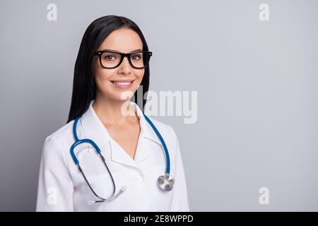 Photo of doctor lady toothy shiny smile look camera wear stethoscope specs white uniform isolated grey color background Stock Photo