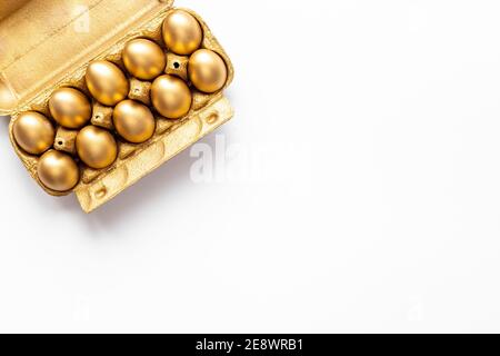 Golden Easter eggs in box cells. Save money. Symbol of wealth and good luck Stock Photo