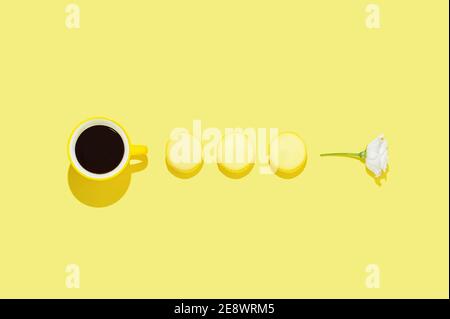 Creative arrangement with cup of coffee on bright yellow background. Minimal  modern good morning concept. Valentines or woman's day background. Stock Photo