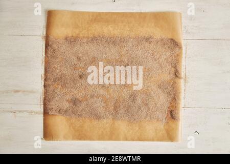 Top view of cinnamon and sugar on a parchment paper for cinnamon rolls on the table Stock Photo