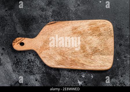 Wooden cutting Board. Black background. Top view. Copy space Stock Photo