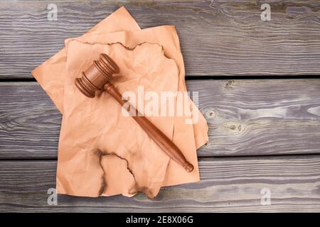 Wooden gavel on beige papers. Stock Photo