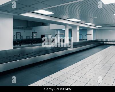 Covid-19 Lockdown - London Luton Airport - Empty Deserted Baggage Carousel at Arrivals - Effects of the travel ban due to the Novel Coronavirus Stock Photo