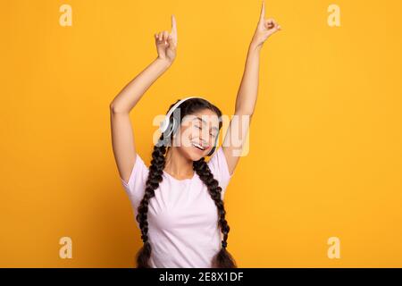 Smiling Young Indian Woman Listening To Music Stock Photo