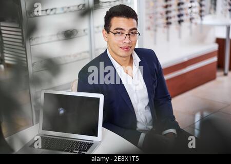 Serene male client seated in an optical store Stock Photo