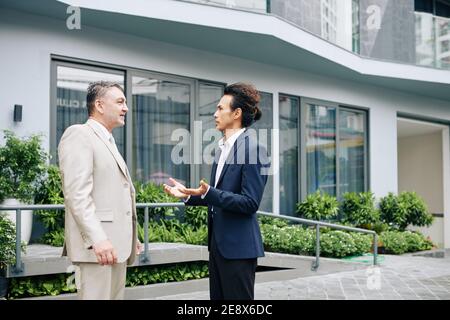 Talking serious business people Stock Photo