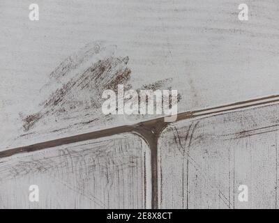 Aerial top down shot of three-way intersection between fields in rural area in winter with snow Stock Photo