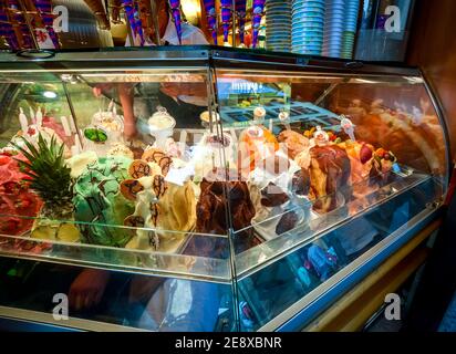 Rows of colorful gelato inside an ice cream shop gelateria in Florence, Italy. Stock Photo