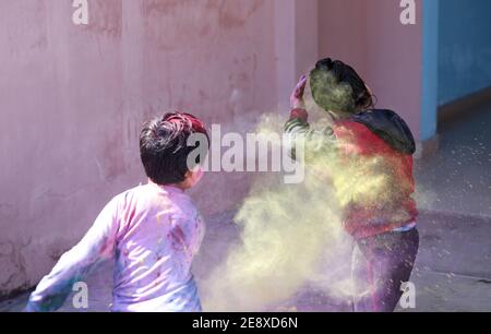 Kids playing with color at home During holi Festival of Colors Stock Photo