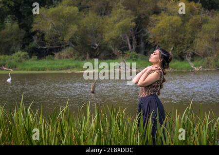 Young Woman Near The Sea Standing In Swimsuit. Portrait Young Model With  Developing Hair In The Wind Stock Photo, Picture and Royalty Free Image.  Image 88301806.