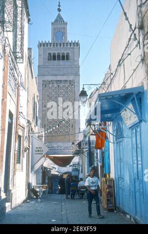 1988 Tunisia Tunis - TunisAl-Zaytuna Mosque, also known as Ez-Zitouna Mosque, and El-Zituna Mosque or Zaytuna Mosque is a major mosque at the center of the Medina of Tunis The mosque is the oldest in the Capital of Tunisia and covers an area of 5,000 square metres (1.2 acres) with nine entrances.The mosque is known to host one of the first and greatest universities in the history of Islam in Tunis, Tunisia, North Africa Stock Photo