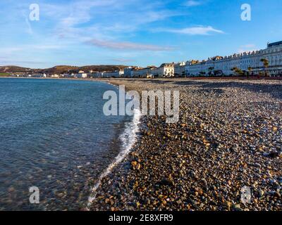 The pebble beach and seafront promenade at Llandudno a seaside resort in Conwy North Wales UK Stock Photo