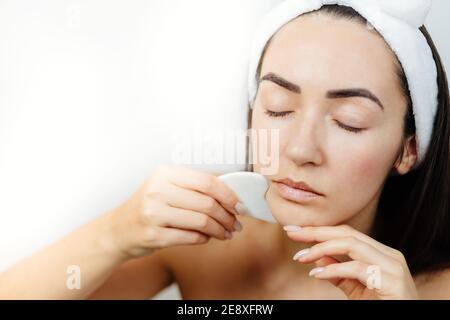woman using gouache scraper massager Stock Photo