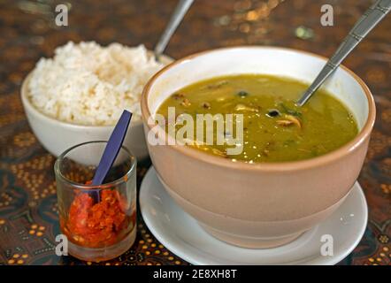 Erwtensoep / green pea soup, a typical Dutch dish, served with rice and sambal in Suriname / Surinam Stock Photo