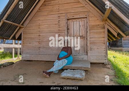 Afro-Surinamese woman posing in front of wooden house in the village Aurora, Sipaliwini District, Suriname / Surinam Stock Photo