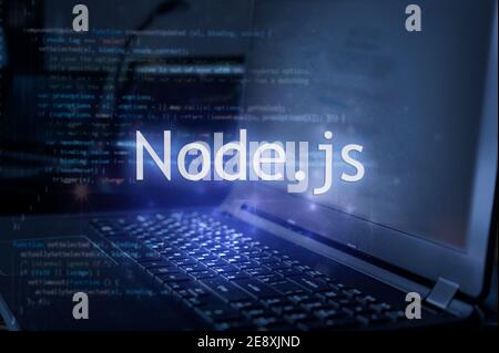 Node.js inscription against laptop and code background. Learn node programming language, computer courses, training. Stock Photo