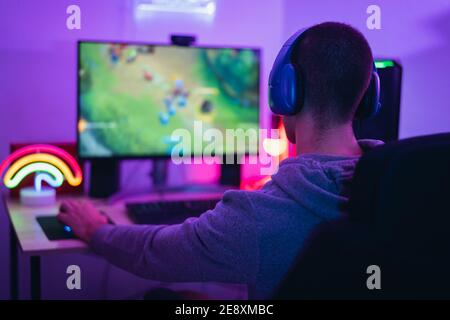 Young gamer playing online video games while streaming on social media - Youth people addicted to new technology game Stock Photo
