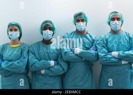 Team of medical workers wearing personal protective equipment against corona virus outbreak - Doctor working for stop and preventing coronavirus Stock Photo