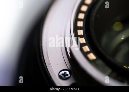 Macro photo of the metal ring on the back of a lens that connects to the camera. Background image Stock Photo