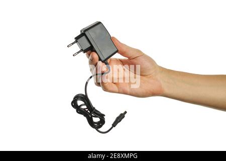 dc power adapter at caucasian persons hand. isolated on a white background. charger tool Stock Photo