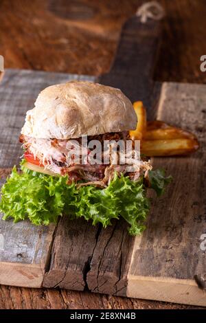 pulled pork in a bun with fries Stock Photo