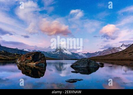 Matterhorn mirrored in the pristine lake Stellisee at dusk,  Zermatt, Valais canton, Switzerland Stock Photo