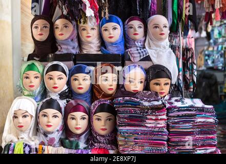 Mannequin of arab women wearing colorful fabric hijab on head in market in Morocco. Concept of travel, religion, islam, clothing, fashion, arab art, Stock Photo